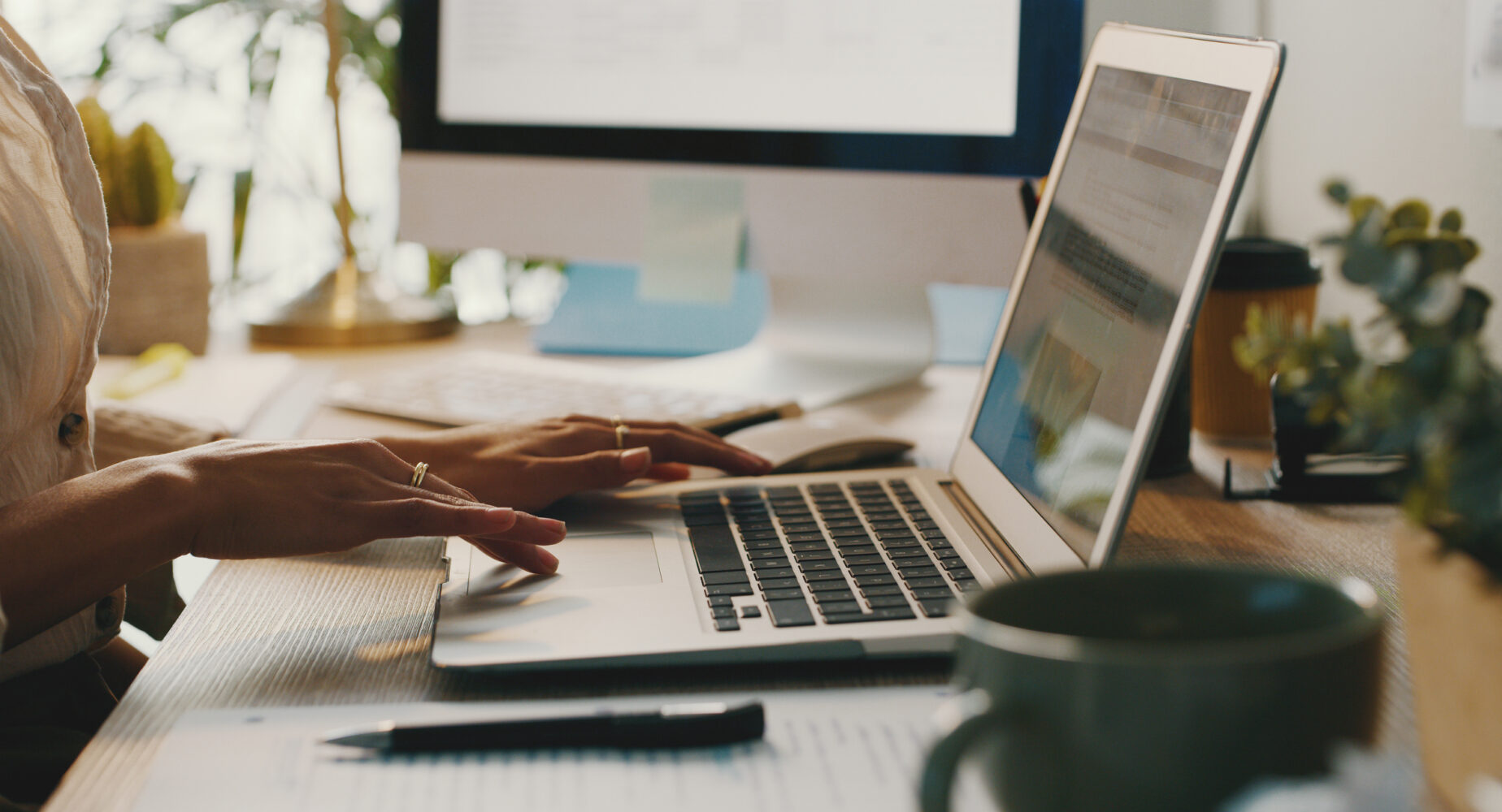 Cropped shot of an unrecognisable businesswoman sitting alone and using her laptop while working from home