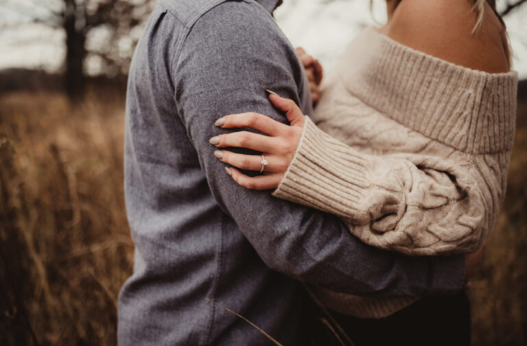 Engagement ring on woman's hand during engagement photography session