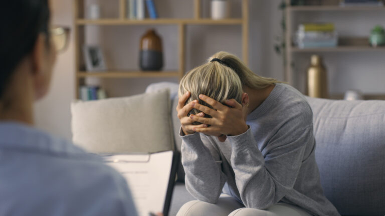 Crying woman, counseling and psychology for therapy, mental health and life crisis. Sad patient, anxiety and depression at psychologist for medical consultation, healing and advice of trauma problem